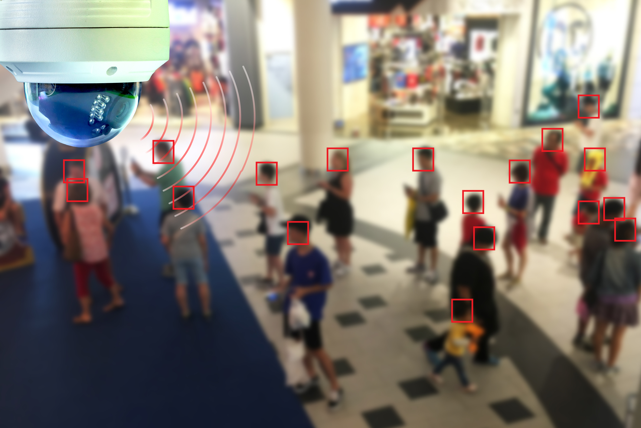 A dome-shaped, AI-powered surveillance camera uses facial recognition to count customers in a mall.